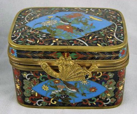 Circa 1900 Meiji Japan Cloisonne Box: Meiji cloisonné box measuring 3" height by 4 1/4" width by 3 1/4" depth. Fan form clasp. An exquisite piece in form, pattern and color.