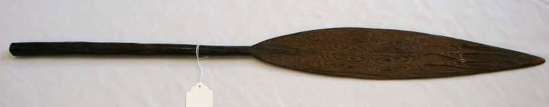 New Guineau Canoe Paddle: Wooden dugout canoe paddle from New Guinea (early 20th century). 36" height by 4" width.