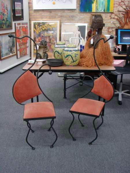 Dolly Moreno 'Chatting' Chairs Brazil: 2 chairs by Brazilian artist Dolly Moreno with steel frames measuring 49" height, 18" width and 13" depth. The chairs are titled "Chatting" and were featured at SOFA Chicago in 1997.