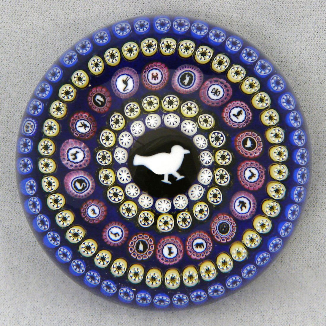 Baccarat 1979 LE Millefiori Gridel Cane Animals Pap: Baccarat Modern 1979 ("B 1979" cane on left of front design and numbered 27 1979) Limited edition: 27 of 350 Description: Gridel bird silhouette cane surrounded by five concentric rings of canes on a