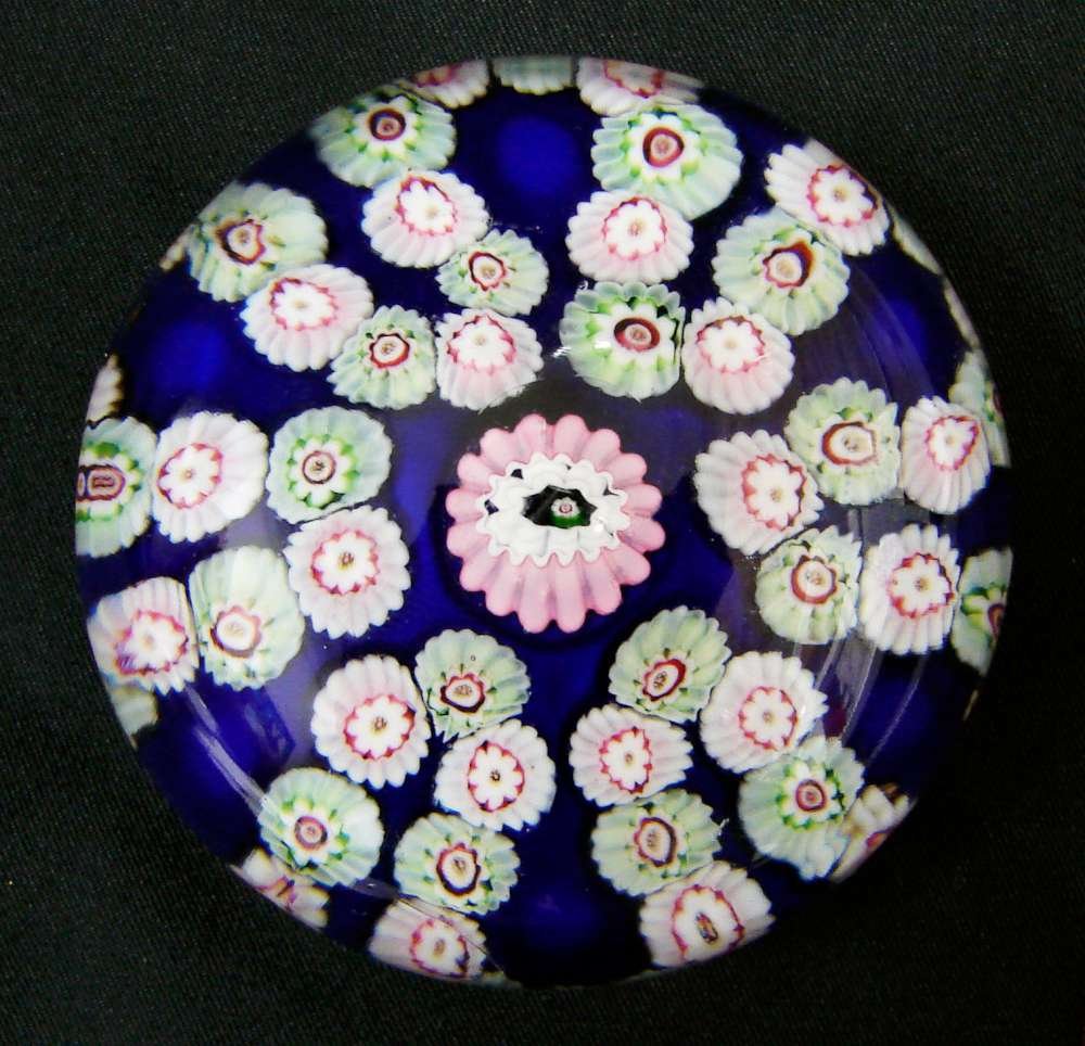 Clichy Antique Paperweight c. 1840: Antique Circa 1840 Clichy paperweight. A rich translucent ground garland weight light green and white canes surrounding a large pink cane. Size: 2 ¾ inches diameter Faceted: No