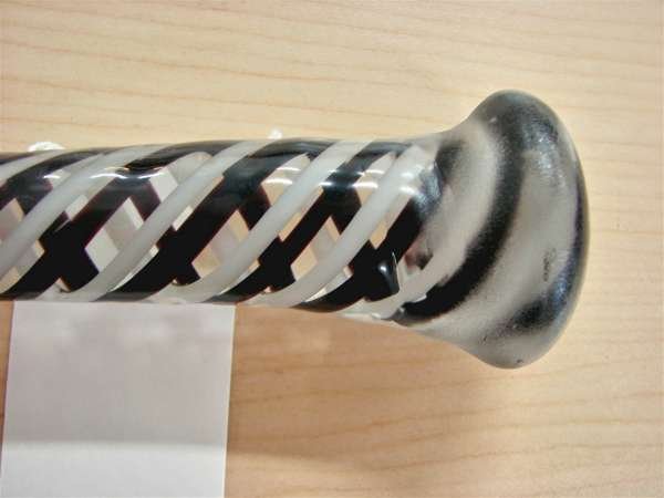 Glass Walking Stick or Cane Black White Mezza Fili: Glass cane or walking stick, American, circa 1900. 49 1/2" length black and white thick cane twisted, minor chip at tip The photographs include two photographs of all of the canes that we are auctioni