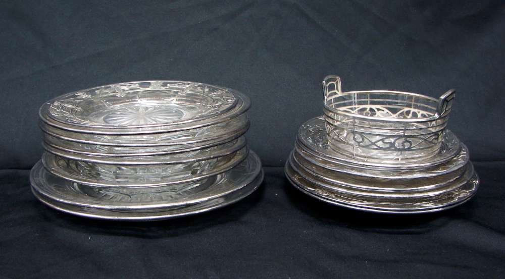 16 Piece Sterling Overlay Lot: Lot of sixteen (16) plates including: three (3) glass plates with the same sterling silver overlay and starburst pattern cut into bottom of glass. "Sterling" stamped into the silver. 7" diameter. Very