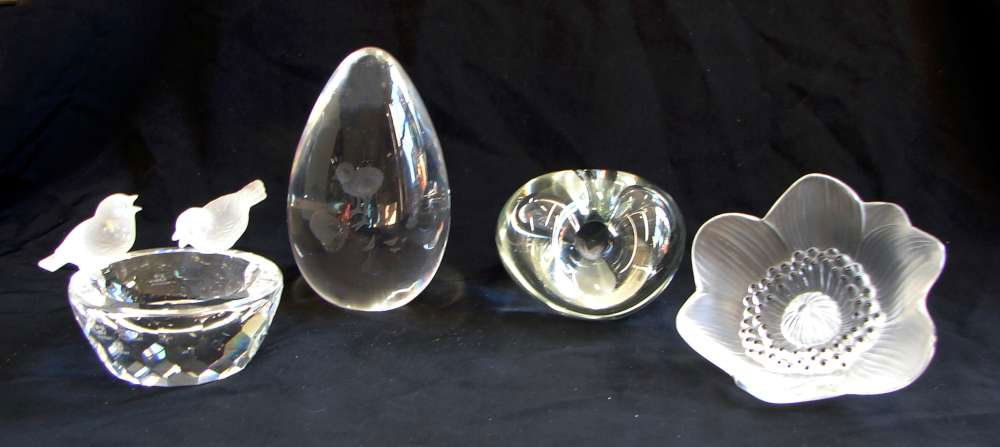 Four Crystal Figures: Lalique Flower, Kosta, Swaro: Lot of four (4) decorative glass items including: 1. One (1) Glass Lalique Flower. "Lalique @ France" etched into stem. 3" height by 5" width; 2. One (1) Glass Neudek Paperweight with hole in the cent