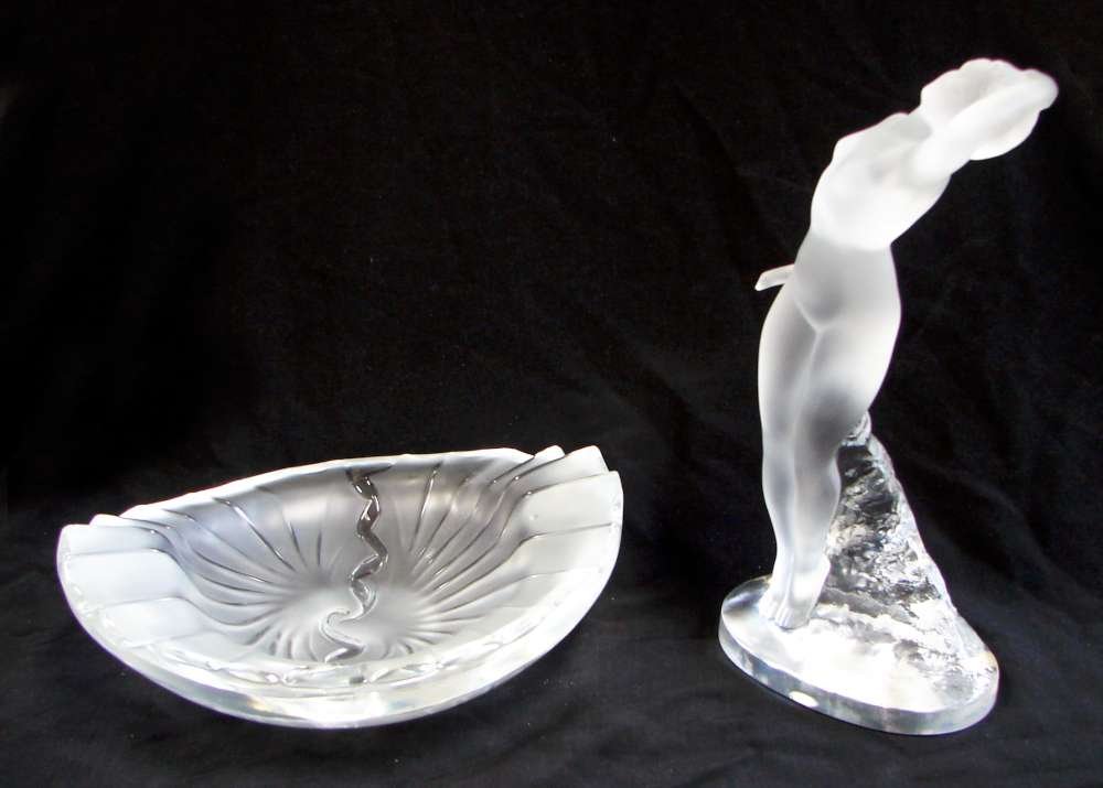 Two Lalique Glass Nude Female Figure and Shell For: Lot of two (2) Lalique Glass items including: One (1) Glass Lalique sculpture of classical nude female in swooning posture. "Lalique France" on bottom. 10" height by 5" width; and one (1) Glass Laliqu