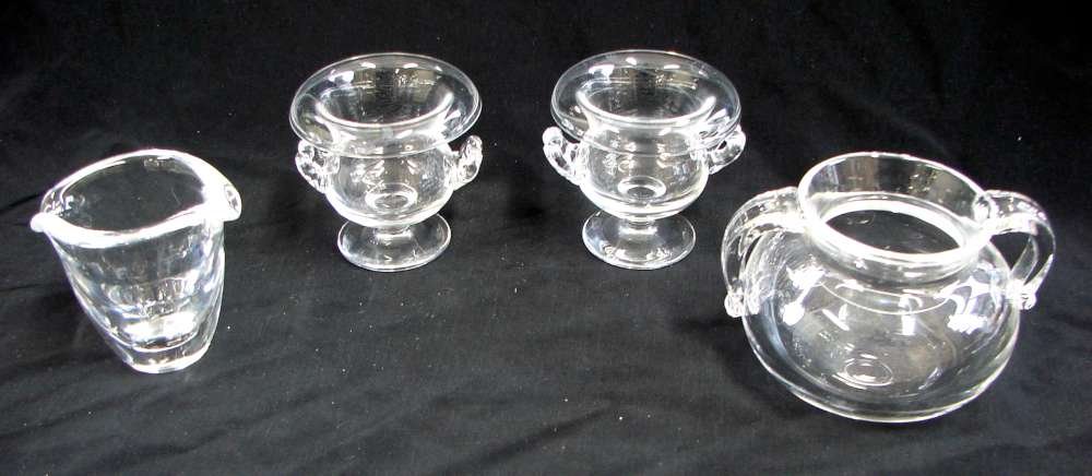 Four Steuben Crystal Items: Lot of four (4) Steuben glass including: Two (2) glass Steuben toothpick holders. Signed "Steuben". Excellent condition; one (1) glass Steuben two-handled sugar bowl. Signed "Steuben". Excellent condi