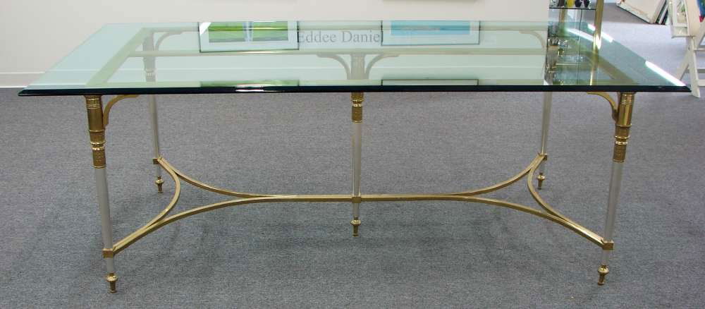 Italian Brass, Glass and Steel Dining Table: Beveled glass top on a steel, brass and gilt steel base. This is an exceptionally elegant and sturdy table. The base and top weigh, together, a few hundred pounds. Measurements: 30" height by 82" leng