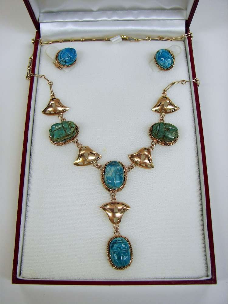 Circa 1900 Egyptian Parure Ancient Scarabs: Circa 1900 Egyptian parure including a necklace of gold and ancient ceramic scarabs and matching clip ear rings. The ear rings are marked with Arabic marks. Each scarab mount also has a jeweler's touc