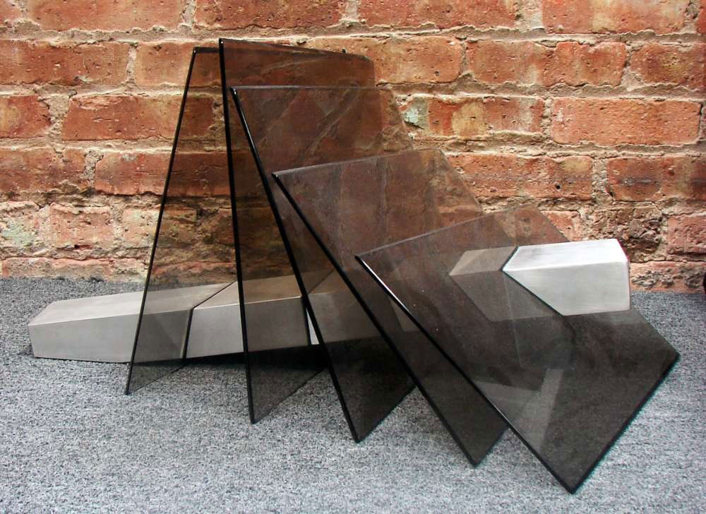 Jack A. Schmidt Steel and Art Glass Sculpture 1979: An art glass sculpture of amethyst glass panels pierced and connected by a steel bar. This sculpture measures 13" height, 26" length and 21" width. Signed and dated "Schmidt 79". Jack Smith is an impo