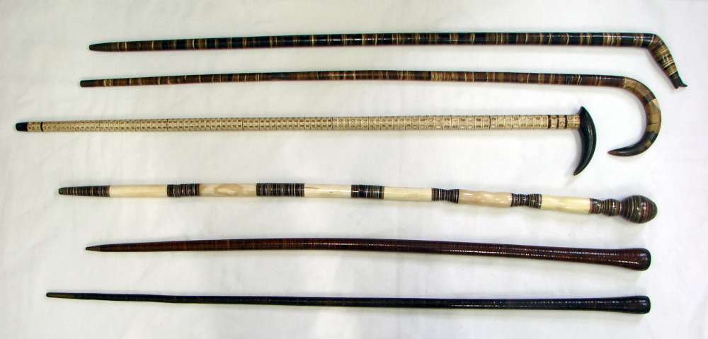 Lot of six (6) Washer Style Canes / Walking Sticks: Lot of six (6) Washer Style Canes; circa 1900. Five (5) canes made from animal horn and one (1) made from shark vertibrae; one cane with boot form handle. Heights vary with tallest measuring 36" and s