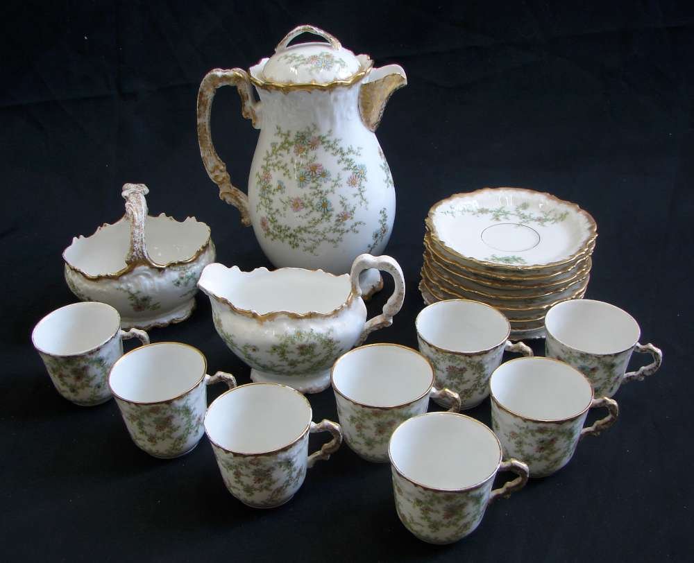 Limoges Porcelain Tea Set Ca 1900 France: Limoges Porcelain Tea Set with raised pink enamel flowers, circa 1900 with two marks, one for the maker, one for the decorator, indicating that this set was both produced and hand decorated in Limoges