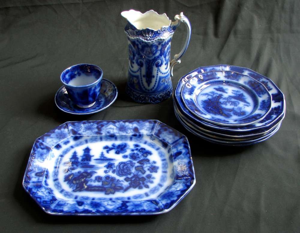 Lot 10 Early Flow Blue English Temple Palew Chapoo Mani: Lot of 10 early English flow blue ceramics including an F&Sons Trellis pitcher; cup and saucer - matched pair - in Temple by PW Co.; an E. Challinor "Palew" plate; a Chapoo plate; a PW&CO. Manilla pla