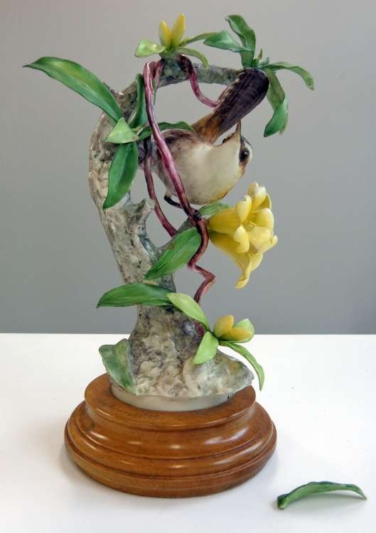 Royal Worcester Doughty Bird Figure Bewick's Wren: Bewick's Wren - a porcelain figure by Dorothy Doughty for Royal Worcester, marked and signed underside, with original wood base, one detached (but available) leaf, otherwise perfect. 9 3/4" height.