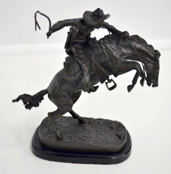 Remington Bronze "Bronco Buster": Frederic Remington's "Bronco Buster" bronze statue. This bronze statue is very heavy and is not made from white metal. It is Made with pride in the U.S.A.