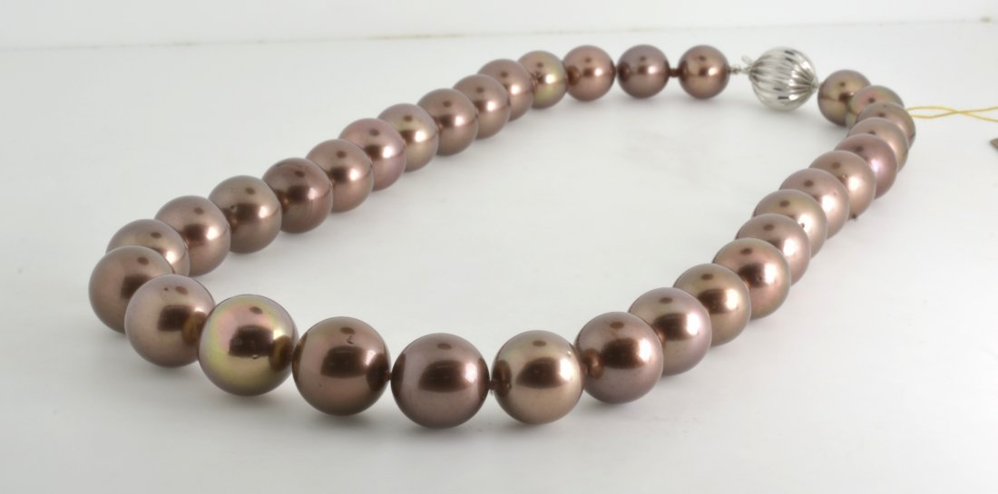 "Chocolate" Tahitian Pearl Necklace Appraised Value: $1: One graduated single strand cultured pearl necklace with a 14K white gold 12 mm scalloped plunger style caslp with 33 "Chocolate" Tahitian Pearls K33J82