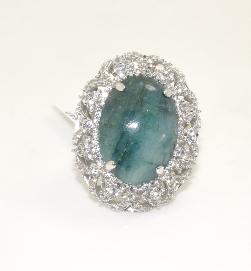 Enhanced Emerald & Sapphire Ring AV: $9,862: Solid platinum plated over silver ring with a 22.26 ct enhanced emerald (beryl) center stone and 3.50 cts of sapphires K49J9
