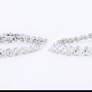 7.10ctw Diamond 18K White Gold Tennis Bracelet: One 18K White Gold Diamond Tennis Bracelet. Weighing 15.38 Grams.Containing: Thirty round brilliant-cut diamonds in bezel set. Total Weight: 7.10 caratsAverage Color: G - HAverage Clarity: SI1 to I1Br