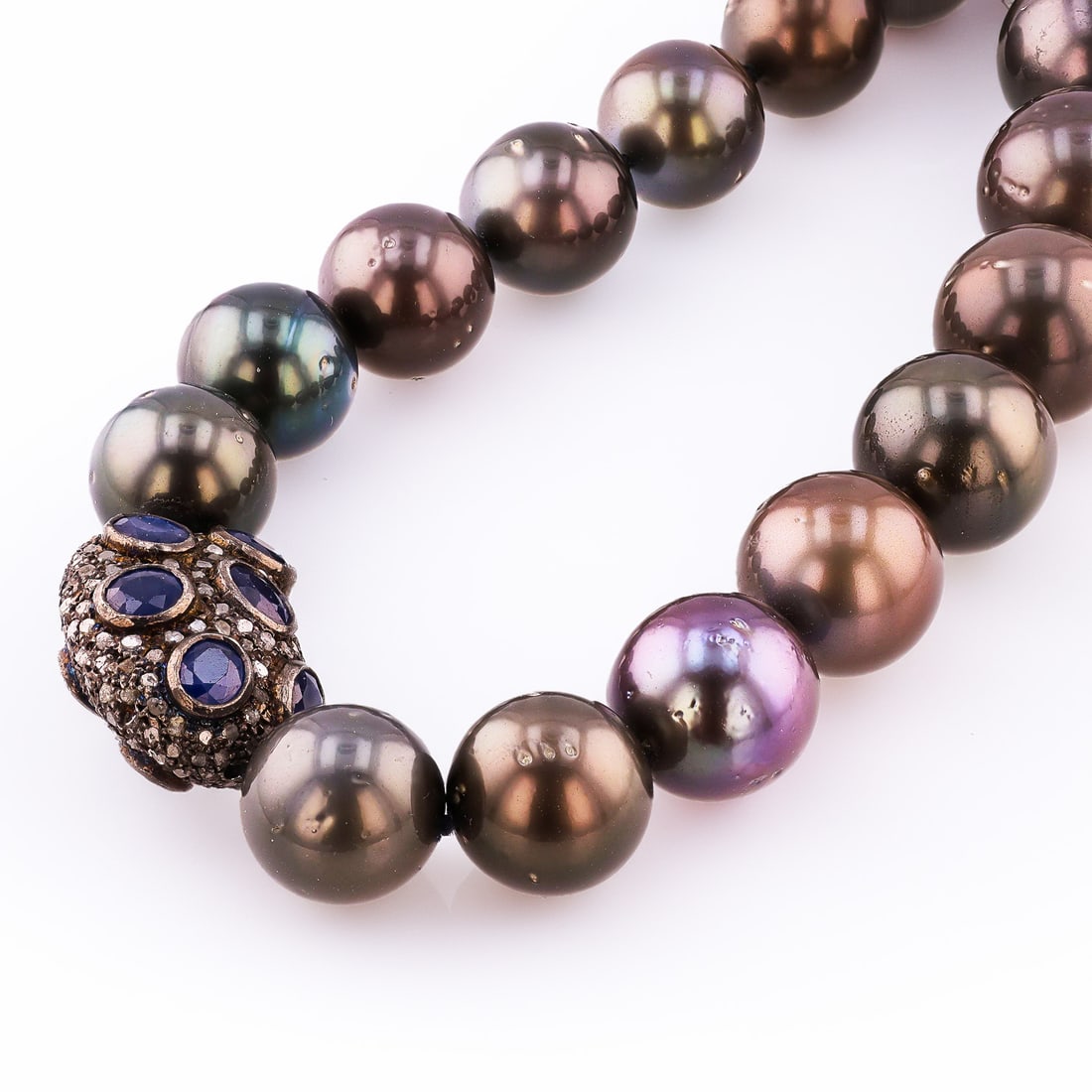 11MM to 14MM Tahitian Cultured Pearl, 5.42ctw Blue Sapphire and 1.29ctw Diamond 14K White Gold: One graduated, single strand, Cultured Tahitian Pearl necklace with a 14K gold accent bead with a black rhodium finish. The bead is set with 12 genuine sapphires weighing approximately 5.42 carats, an