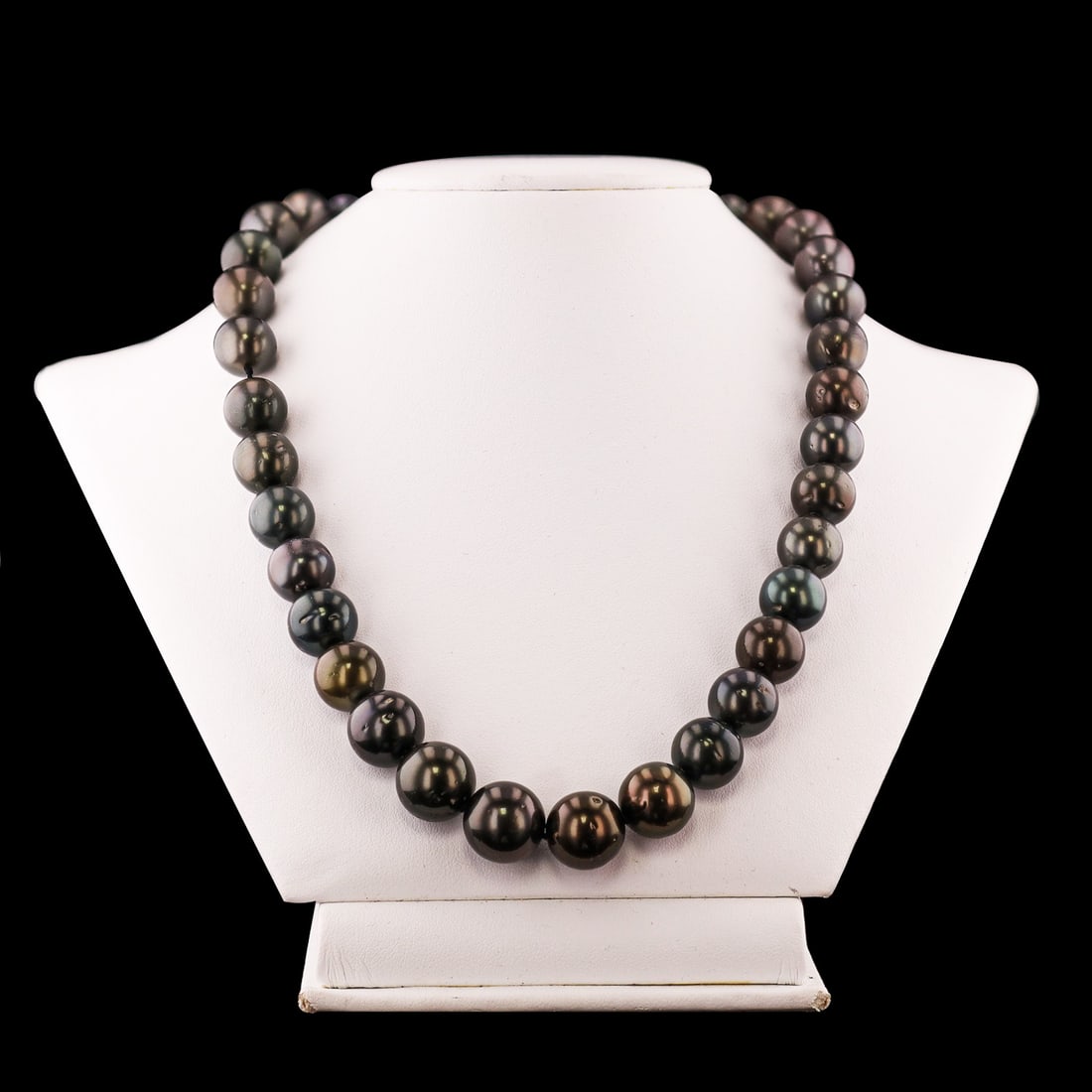 11mm to 13mm Tahitial Cultured Pearl Necklace with 14K White Gold Clasp: One graduated single strand Cultured Tahitian Pearl necklace. The strand has each pearl individually hand knotted and is finished with a 14K white gold plunger style tension locking scalloped bead cla