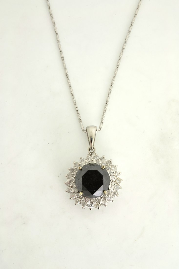 Black & White Diamond Necklace AV: $11,950: 14K white gold ladies necklace with a 5.81 ct fancy black diamond center stone with 0.74 cts of white diamond (I1-I2, G-I color) K35J96