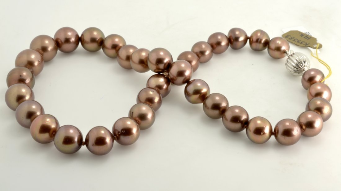 "Chocolate" Tahitian South Sea Pearls AV: $13,100: "Chocolate" Tahitian South Sea Pearl necklace knotted with a 14K white gold 14 mm scalloped plunger style clasp. There are 35 individual "Chocolate" Tahitian South Sea Pearls between 10.50 mm and 13.0
