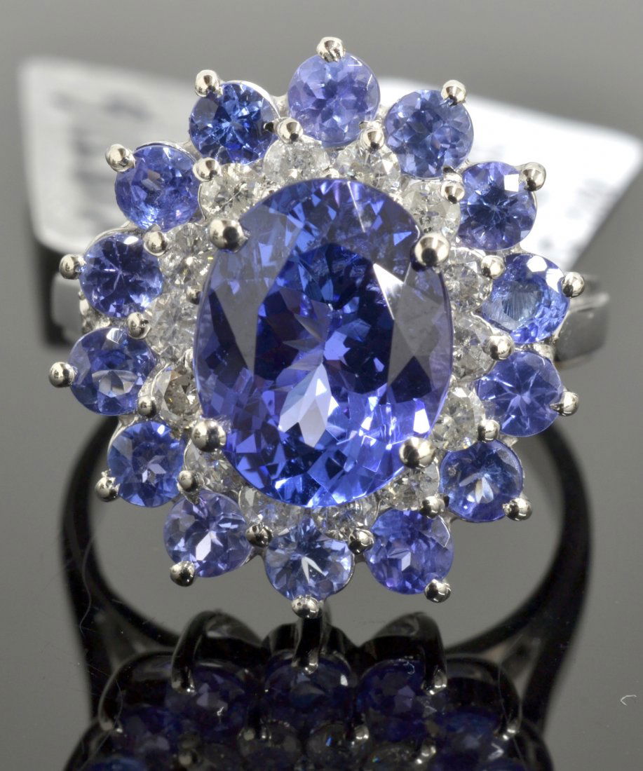 Tanzanite & Diamond Ring Appraised Value: $8,960: 14K white gold ladies cast tanzanite and diamond ring with 0.43 ct of diamonds, 14 = 1.20 ct prong set round cut natural tanzanites, and a centered oval mixed cut 2.63 ct tanzanite K18J16