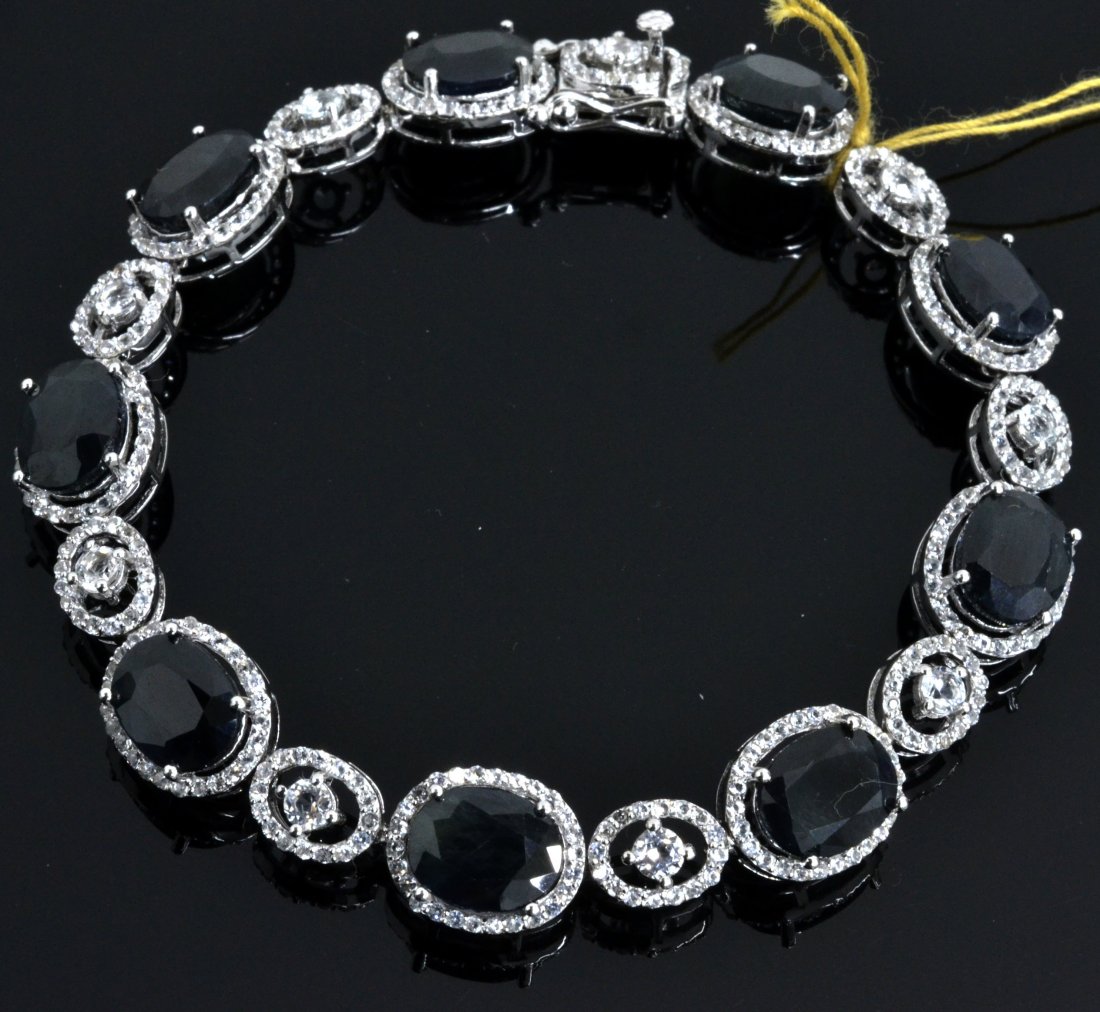Sapphire & Topaz Bracelet Apparised Value: $9,300: Platinum plated/silver bracelet with 3.40 ct of colorless topazs and 24.03 ct of blue sapphires K11J49