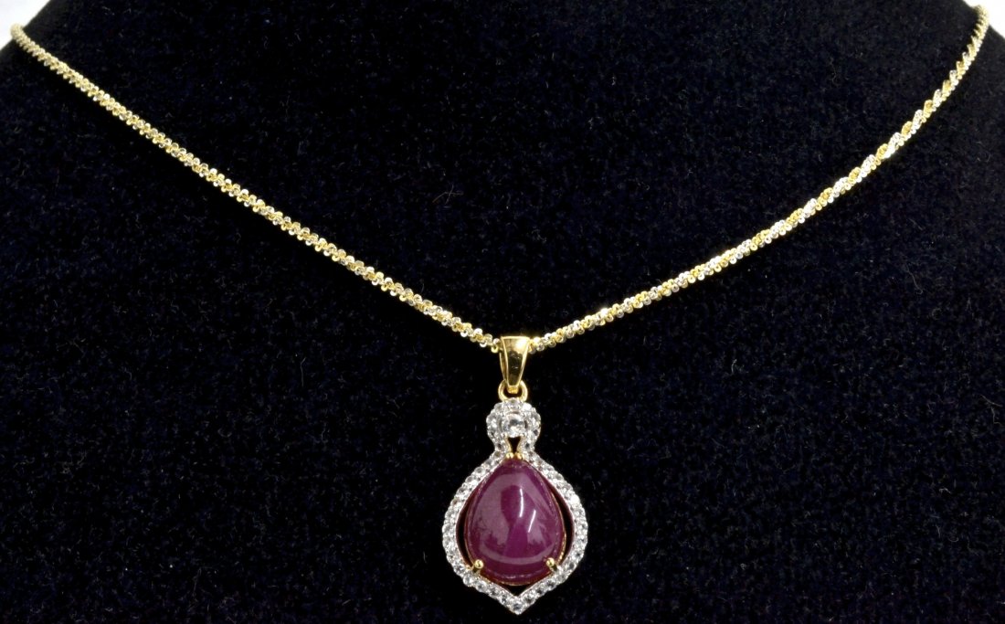 Ruby & Topaz Necklace Appraised Value: $3,110: Ruby and topaz necklace with 0.47 ct of colorless topaz and a centered 9.02 ct pear red ruby K31J1