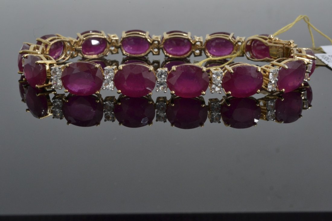 51.19 ct Ruby & Sapphire Bracelet AV: $12,320: 925 silver ladies cast ruby and sapphire bracelet with 2.65 ct of prong set round brilliant cut natural white sapphires and 14 = 48.54 ct prong set oval mixed cut rubies K85J2