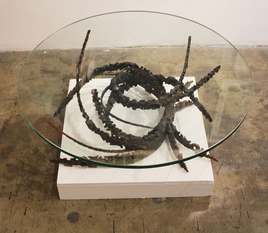 Daniel Gluck, Swirl, c. 1969: Glass and steel coffee table 40" diameter glass on 14 3/4" high sculpturebr>Provenance: Artist Estate