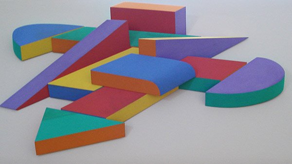 John Okulick, Central City, 1983: Painted wood assemblage Signed, titled and dated in ink on verso Image: 2.5 x 4.5 x 8 feet