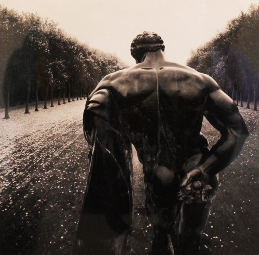Michael Kenna (1953): Hercules, Vaux-Le-Vicomte,France, 1998 Sepia Toned Gelatin Silver Print Signed, dated, and numbered on recto from an edition of 45 Image: 7 7/8 x 7 5/8 inches Framed: 22 1/4 x 18 1/4 inches