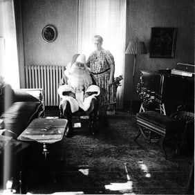 Diane Arbus (1923-1971): Mr. and Mrs. Santa Claus in their living room, Albion, N.Y., 1964