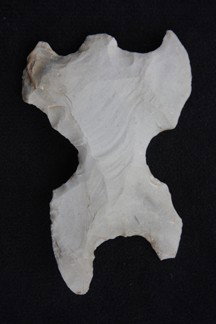Mayan Eccentric: Mayan Eccentric from Mexico collected in the late 1920's Chipped in the effigy for of a human. Slight damage chip to one foot. It measures 3.14" long x 2.10" wide.
