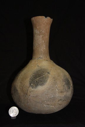 Mississippian Water Bottle: Having a long neck this bottle is from Missouri. It shows pressure cracking it has been glued but not yet restored and has a small rim piece missing. 9" H x 6 1/2" D.