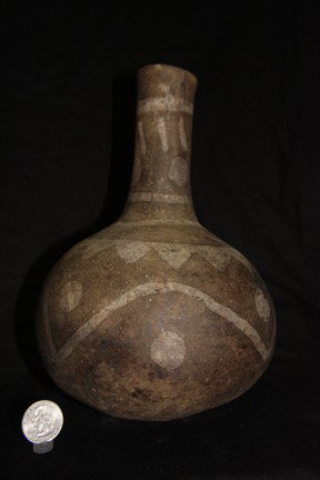 Water Bottle: This long necked water bottle has shell tempering and is negatively painted. Solid with no damage noticed. Believed to be from Kentucky. 9" H x 6 ½" D