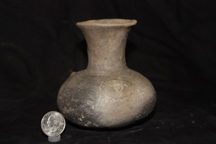 Miniature Water Bottle: This small bottle has three human face medallions, a flaring neck and a squatty body. There is some pressure cracking and approximately 30% of the rim is restored. It was found in Arkansas. 4 ½" H x 