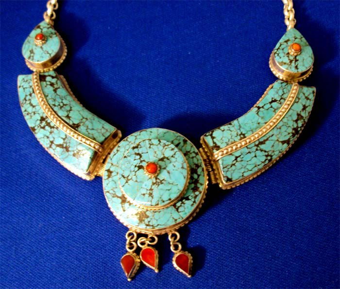 Elegant Nepalese Turquoise Silver & Coral Necklace: Turquoise set in sterling silver with small coral accents, necklace width is 5", silver chain is 14" not counting turquoise part.