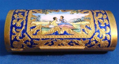 Italian Oblong Enamel Silver Compact Couple In Field: Very unusual cylindrical container extensively decorated with a gilded metal and carnelian blue enamel decoration, in the center is a wonderful enamel painting of a couple in a field, excellent mint c