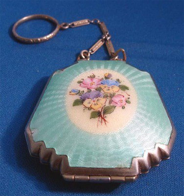 Hand Guilloche Floral Enameled Silver Powder Blue: Beautiful floral enamel painting is framed by a powder blue guilloche design in this nice silver compact. The reverse is the powder blue guilloche as well, there is a small piece missing (see photo). 