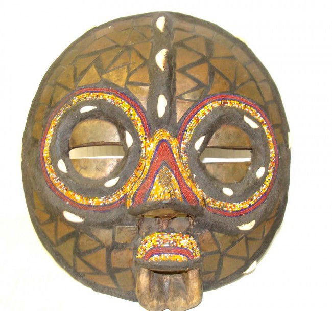 Primitive Antique African carved Wood Mask w Shells: Wood carved mask with Puka Shells accents and extensive beadwork, from the Lee Estate collection of Masks. Dimensions 12" by 13"