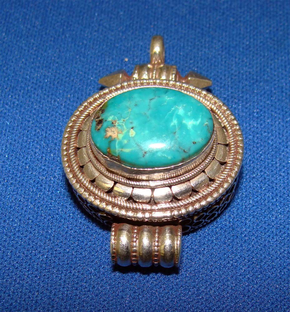 Nepalese Tibetan Gau Turquoise and Silver Pendant: Traditional Gau Pendant from Tibet, elegant and generously-sized Tibetan pendant from Nepal. Included is a beautiful and genuine Turquoise gem-stone, set into sterling silver. There is intricately det
