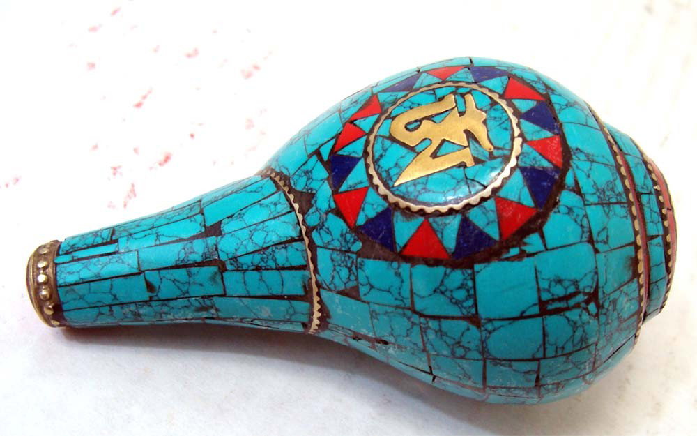 Nepalese Ritual Conch Shell Inlaid Turquoise Lapis silv: This unusual and wonderful Tibetan Ritual Conch Shell is beautifully carved with semi precious stones, coral, turquoise and silver. Dimensions 3.5" by 2.5"