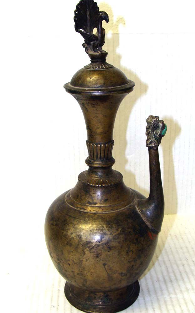 Nepalese Tibetan Antique Newari Alcohol Peacock Pot: Made of a bronze metal casting, topped by a peacock adorned lid, the spout has inlaid turquoise. Dimensions 14" tall by 6" diameter, PAK3W06