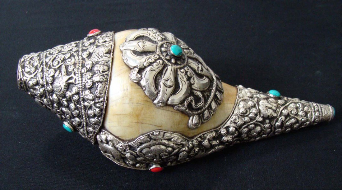 Nepal Ceremonial Conch shell: This beautiful Ritual Conch Shell is carved with silver and semi precious stones, turquoise and coral Dimensions 3.5" by 8.5" TAK3W76