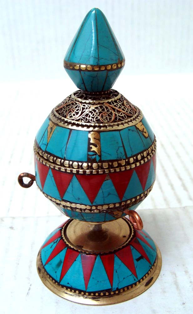 Tibetan Table Prayer Wheel Turquoise, Coral Silver: A prayer wheel is a holy object containing the Tibetan mantra "Om! Mane Padme Hum!" ("Hail! Jewel in the Lotus!") written many times on a scroll of paper rolled up inside. Dimensions 5" by 2.5"