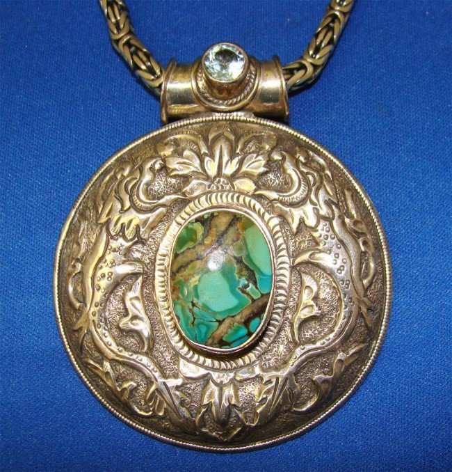 Nepal Sterling Silver Turquoise Pendant & Heavy C: Large Turquoise stone set in a Large engraved sterling silver pendant, accented by a clear blue stone at the top, with a heavy sterling silver 29" long chain. Total Weight 5.8 oz CLK45W2 From the Beve