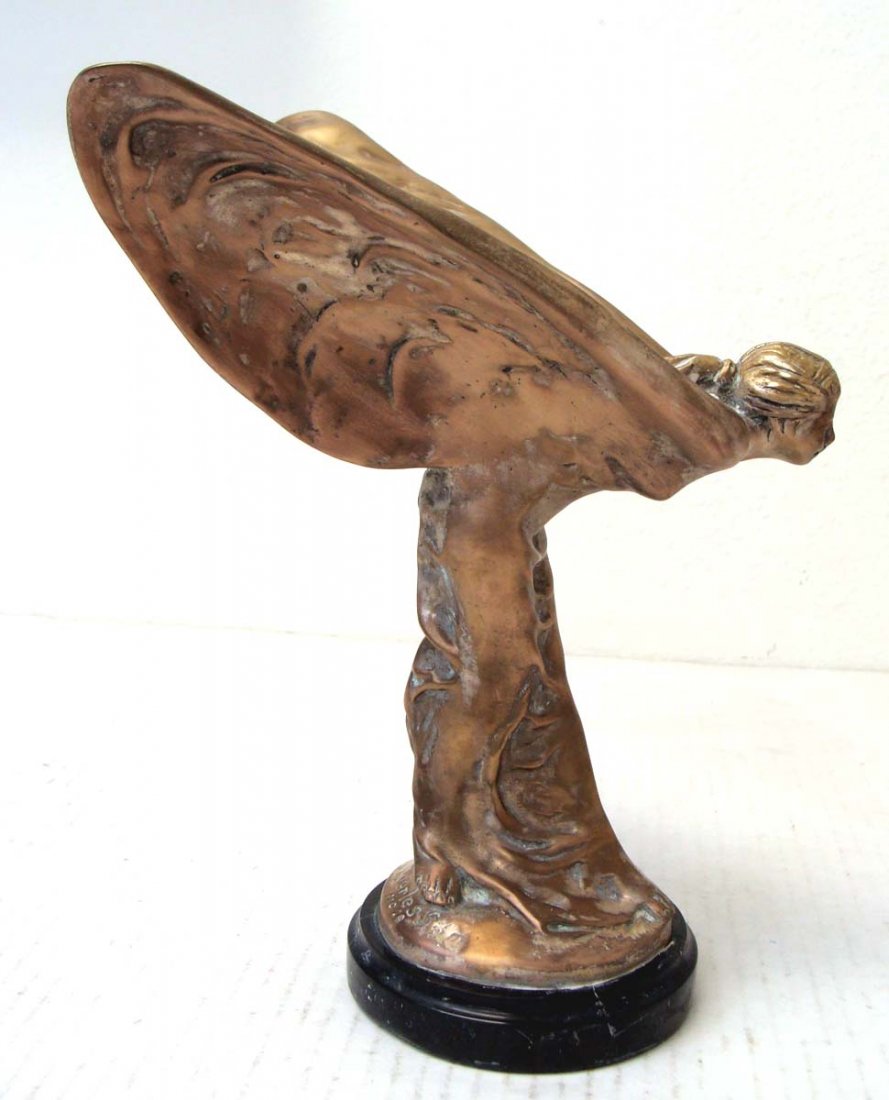 Bronze Rolls Royce Hood Sculpture 9" tall Marble base: This is a beautiful rendition of the famous Rolls Royce Hood Ornament, Originally sculpted by Charles Robinson Sykes, "Spirit of Ecstasy" was originally designed by Sykes to be the mascot for the Roll