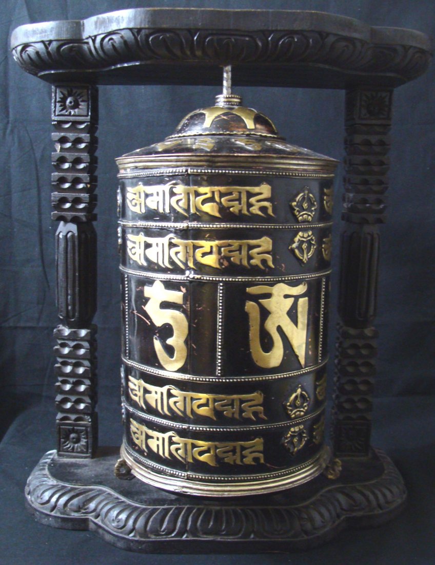 Large Nepal Tibetan Wall Black Copper Prewheel: Wood Frame is used to hang from a wall, Dimensions 16" by 14" by 8" A prayer wheel is a holy object containing the Tibetan mantra "Om! Mane Padme Hum!" ("Hail! Jewel in the Lotus!") written many times