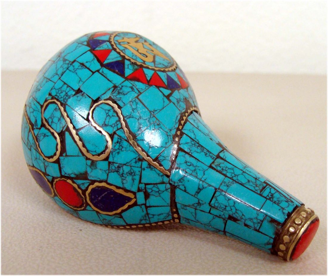 Nepalese Ritual Conch Shell Inlaid Turquoise Lapis: K8W5 This unusual and wonderful Ritual Conch Shell is beautifully carved with semi precious stones and silver. Dimensions 3.5" by 2."